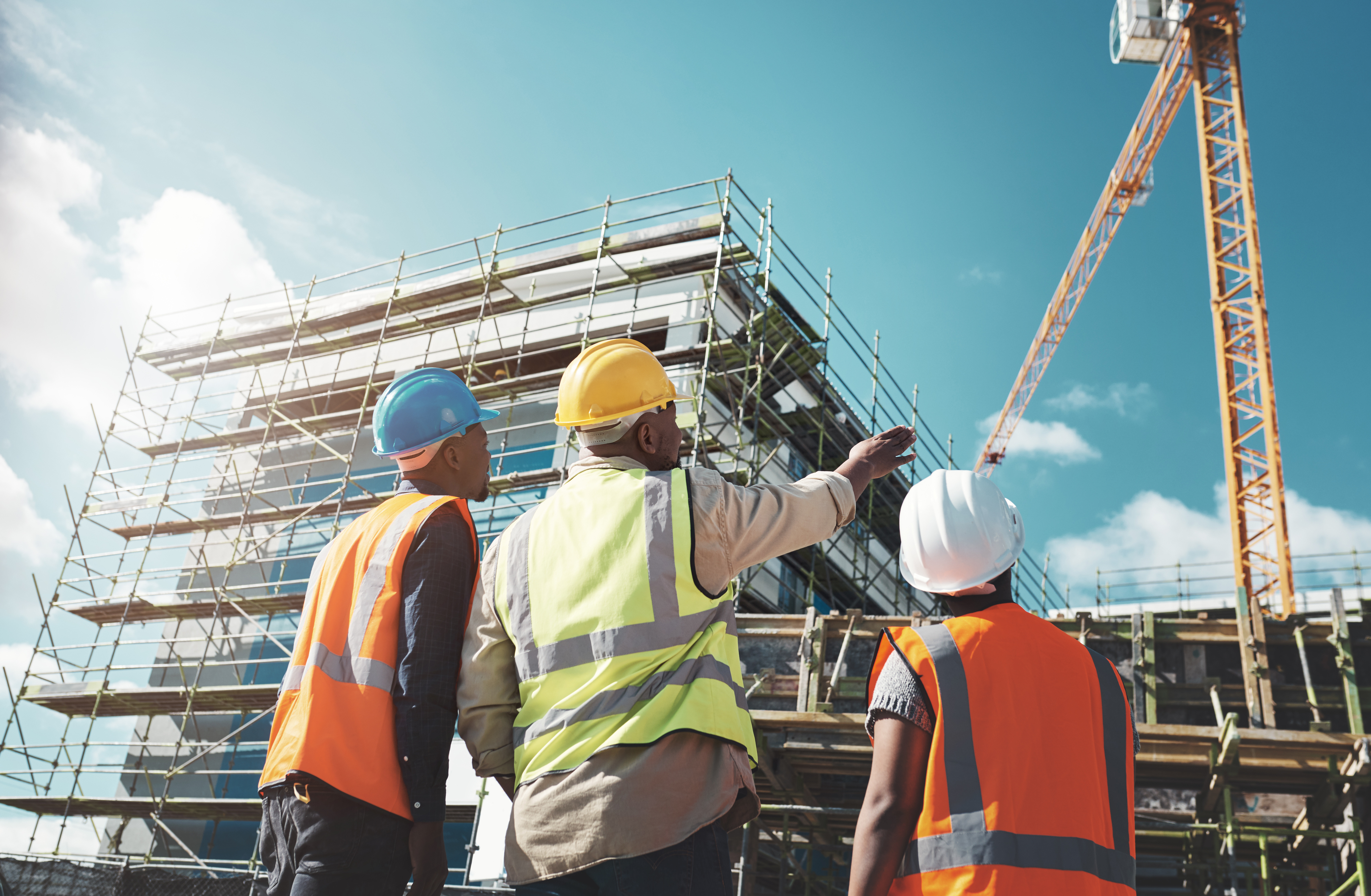 Construction workers overseeing building construction on a job site